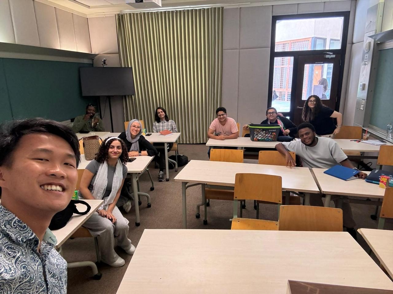 LIC students smiling together in a classroom at a language class